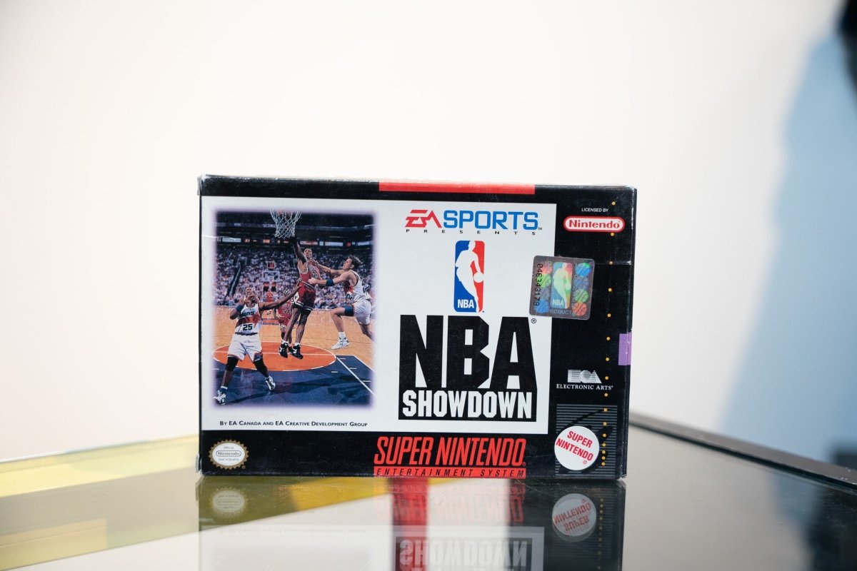 SNES NBA Showdown box with basketball players under basket, EA Sports logo, NBA holographic sticker, Licensed by Nintendo