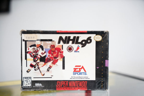 SNES NHL 96 box with New Jersey Devils and Detroit Red Wings hockey players, EA Sports logo, NHL and NHLPA logos, significant box wear