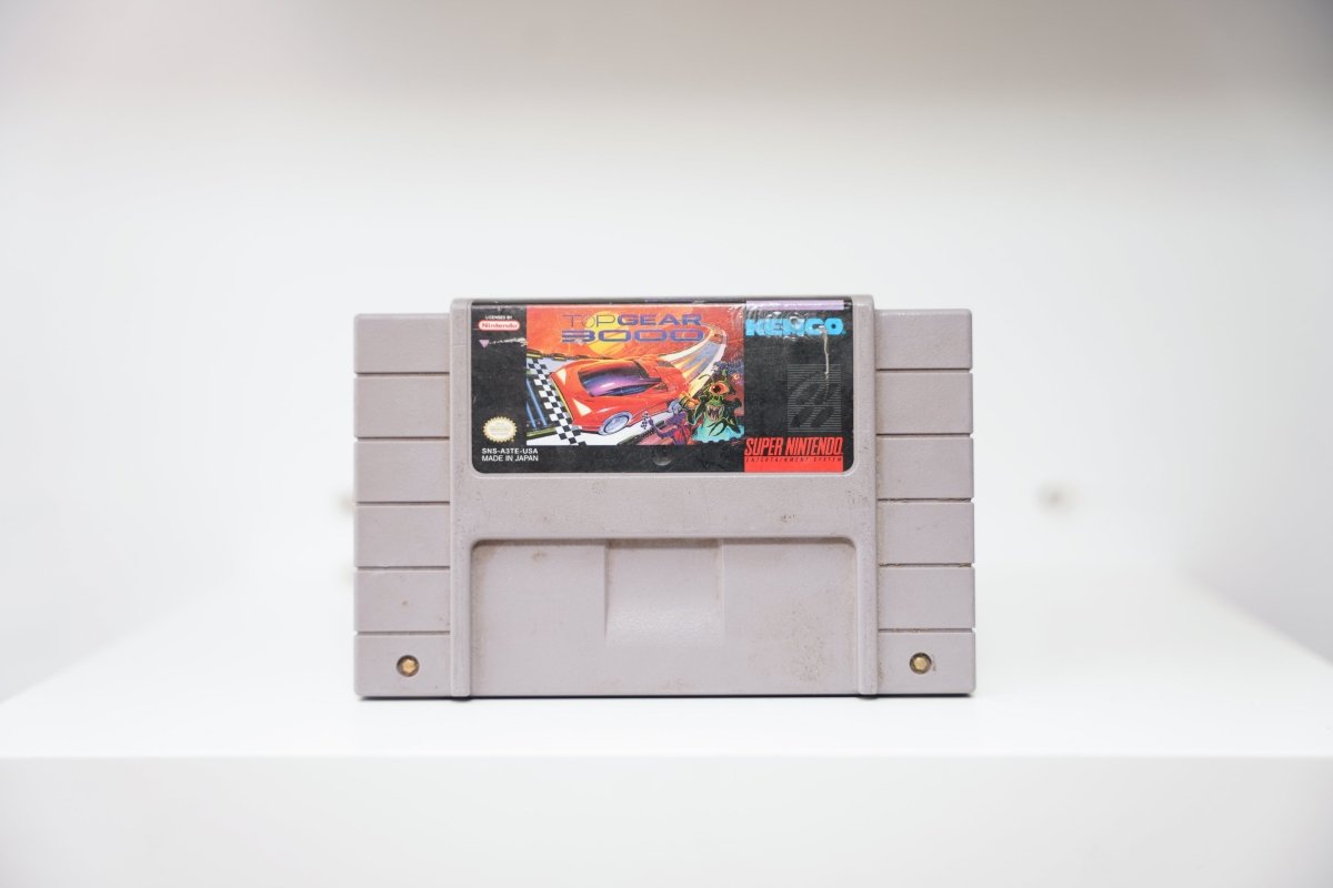 SNES Top Gear 3000 grey cartridge with futuristic red race car and alien character, checkered flag, Kemco logo