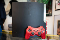 Sony PlayStation 3 Slim 250GB black gaming console shown from front angle, circa 2009
