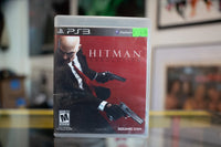 Sony PlayStation Hitman Absolution PS3 game case showing cover art with suited assassin character against dark background