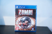 PS4 Zombi blue case extreme close-up bloodshot eye zombie reflection ZOMBI distressed blood-splattered text Ubisoft PEGI 18