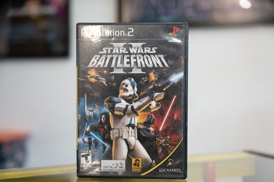 PlayStation 2 Star Wars Battlefront II case with 501st Clone Trooper blaster raised Darth Vader starfighter battles silver title LucasArts Pandemic