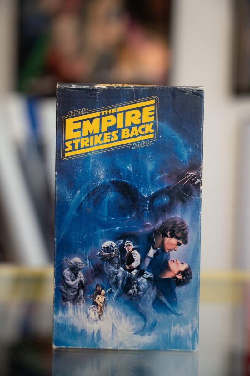 Star Wars The Empire Strikes Back VHS tape with painted art of Darth Vader looming over Han Leia Luke and Yoda with yellow title