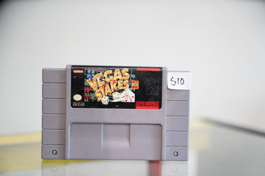 Super Nintendo Vegas Stakes gray SNES cartridge with gold red Vegas Stakes lettering playing cards dice roulette table dark label