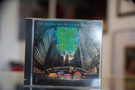Teenage Mutant Ninja Turtles 1990 original motion picture soundtrack CD with Turtles peeking from NYC manhole cover art