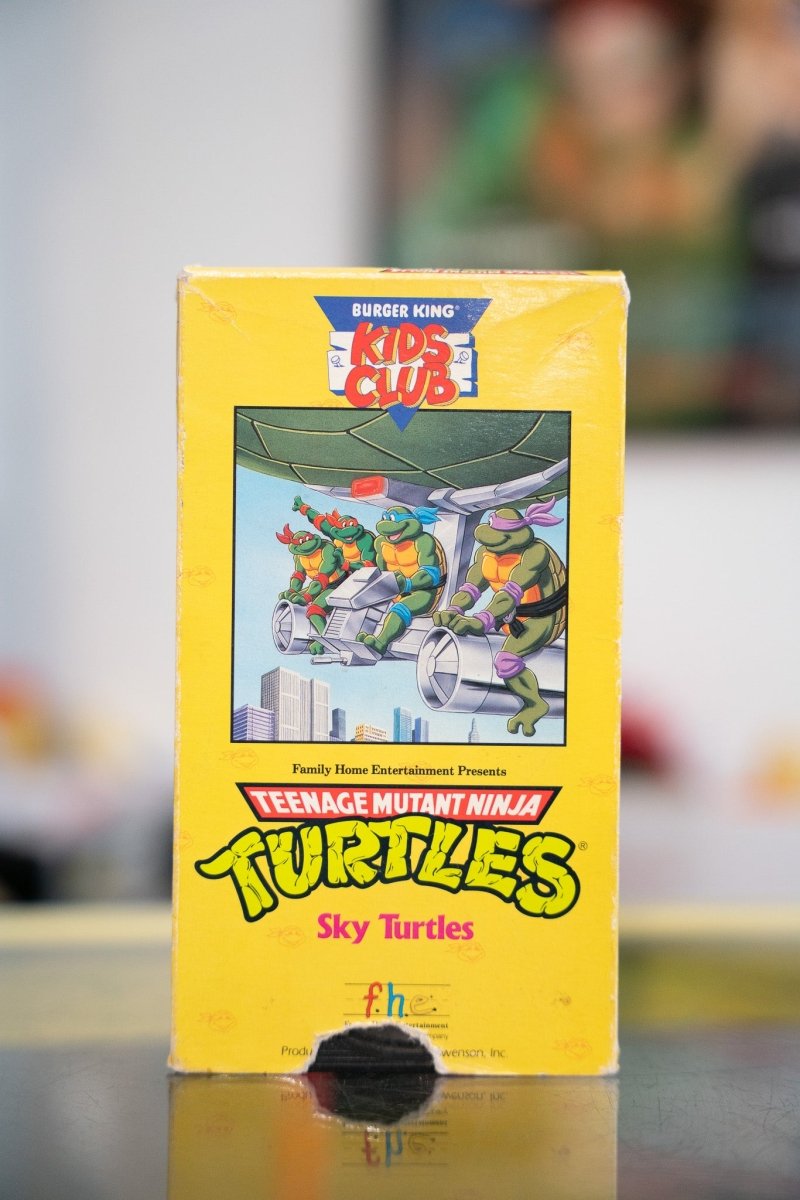 Yellow Teenage Mutant Ninja Turtles Sky Turtles VHS with Burger King Kids Club logo four Turtles in flying vehicle over city and classic TMNT logo