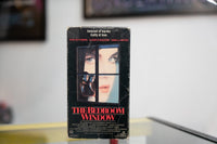 The Bedroom Window VHS dark sleeve with woman looking through window panes couple embracing behind glass red title Innocent of murder Guilty of love tagline