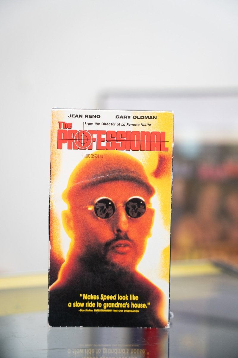 The Professional VHS tape with Jean Reno in round sunglasses and orange-toned cover art with crosshair title design