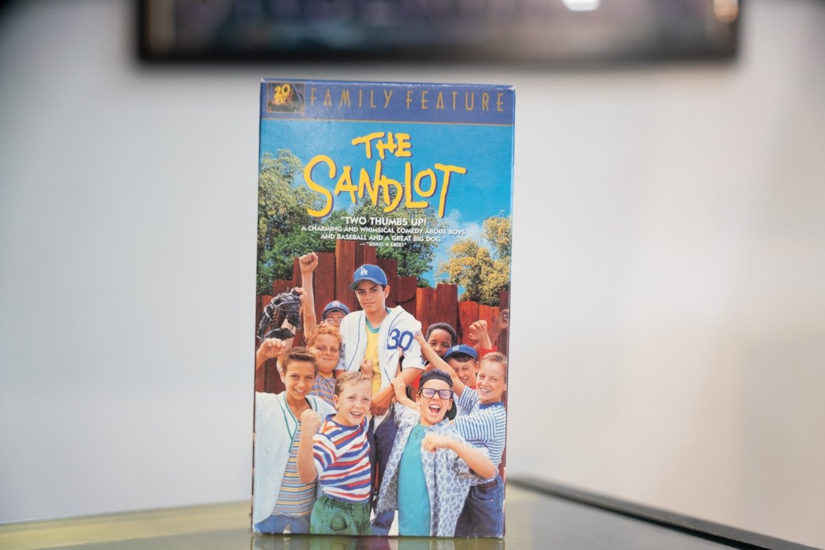 The Sandlot VHS blue sky sleeve with boys cheering fists raised at wooden fence Dodgers cap yellow handwritten title Siskel Ebert quote Fox