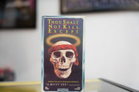 Thou Shalt Not Kill Except VHS purple sleeve with large skull wearing red bandana golden halo yellow gold title StarMaker Entertainment Not Rated