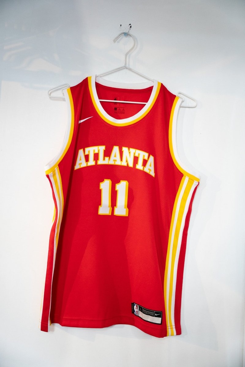 Red Trae Young Atlanta Hawks number 11 Nike NBA Authentics jersey with gold ATLANTA arched lettering and white side stripes size Youth Large