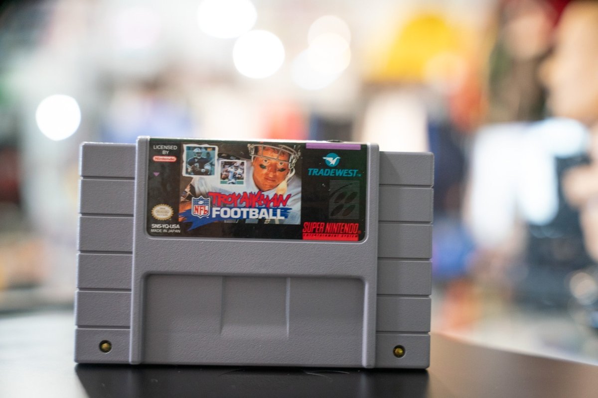 Tradewest Troy Aikman NFL Football cartridge for Super Nintendo SNES, 1994 release with original black plastic casing and printed label