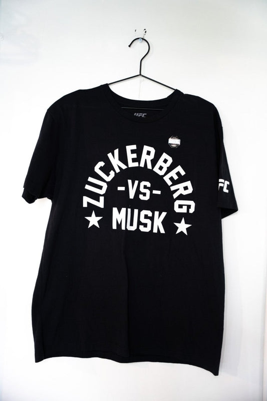 Black UFC Zuckerberg vs Musk t-shirt with white arched ZUCKERBERG text VS and MUSK lettering with stars UFC sleeve logo size XL