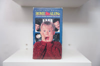 VHS Home Alone VHS tape with original artwork featuring Macaulay Culkin character, 1990s release