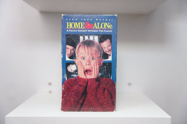 VHS Home Alone VHS tape with original artwork featuring Macaulay Culkin character, 1990s release