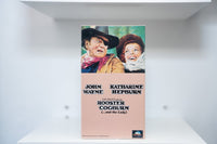 VHS Rooster Cogburn painted cover John Wayne black cowboy hat Katharine Hepburn bonnet ROOSTER COGBURN black text and the Lady MCA Universal