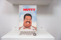 VHS The Nutty Professor blue sky cover Eddie Murphy Professor Klump prosthetic makeup glasses bow tie THE NUTTY PROFESSOR red text Universal PG-13