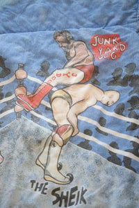 WWF 1980s wrestling comforter featuring Hulk Hogan, Roddy Piper, Junk Yard Dog, and The Sheik printed on fabric with broken zipper