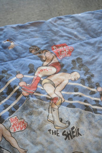 WWF 1980s wrestling comforter featuring Hulk Hogan, Roddy Piper, Junk Yard Dog, and The Sheik printed on red fabric with broken zipper