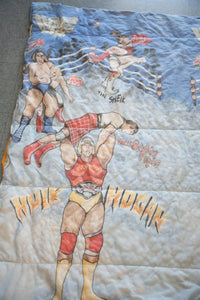 WWF 1980s wrestling comforter featuring Hulk Hogan, Roddy Piper, Junk Yard Dog and The Sheik printed on blue fabric with broken zipper