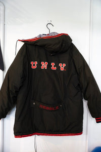 Starter 1991 UNLV Runnin' Rebels red and black nylon parka jacket, size XL, with missing zipper and "Fireman" design visible on front