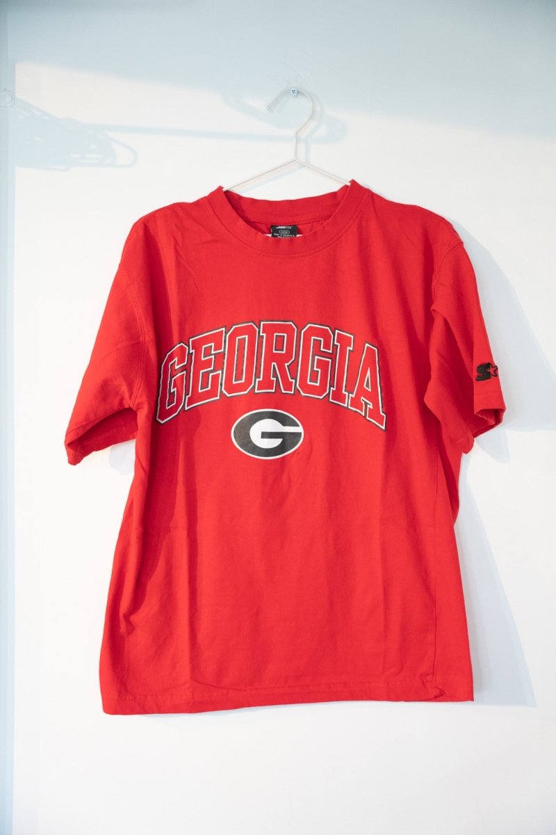 Red vintage Georgia Bulldogs Starter tee with black GEORGIA arched block lettering oval G logo Starter sleeve logo size Large