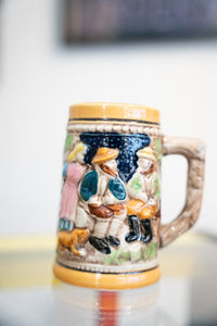 Collectible brand German mini beer stein with blue and white ceramic decoration and metal lid closure, vintage piece