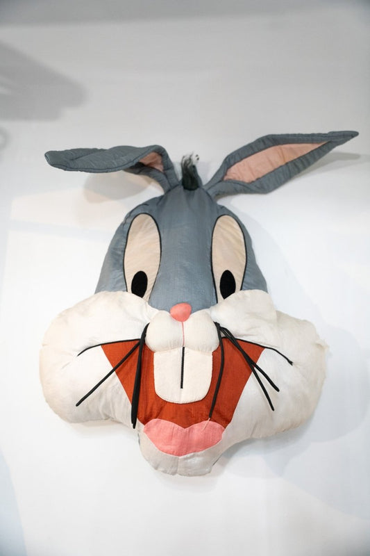 Vintage Looney Tunes Bugs Bunny oversized face pillow with gray ears, white cheeks, buck teeth, and black whiskers