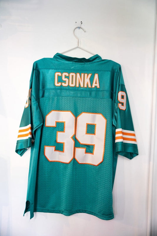 Mitchell & Ness throwback Miami Dolphins #39 football jersey in aqua and orange, size medium, displayed flat showing front torso and sleeve