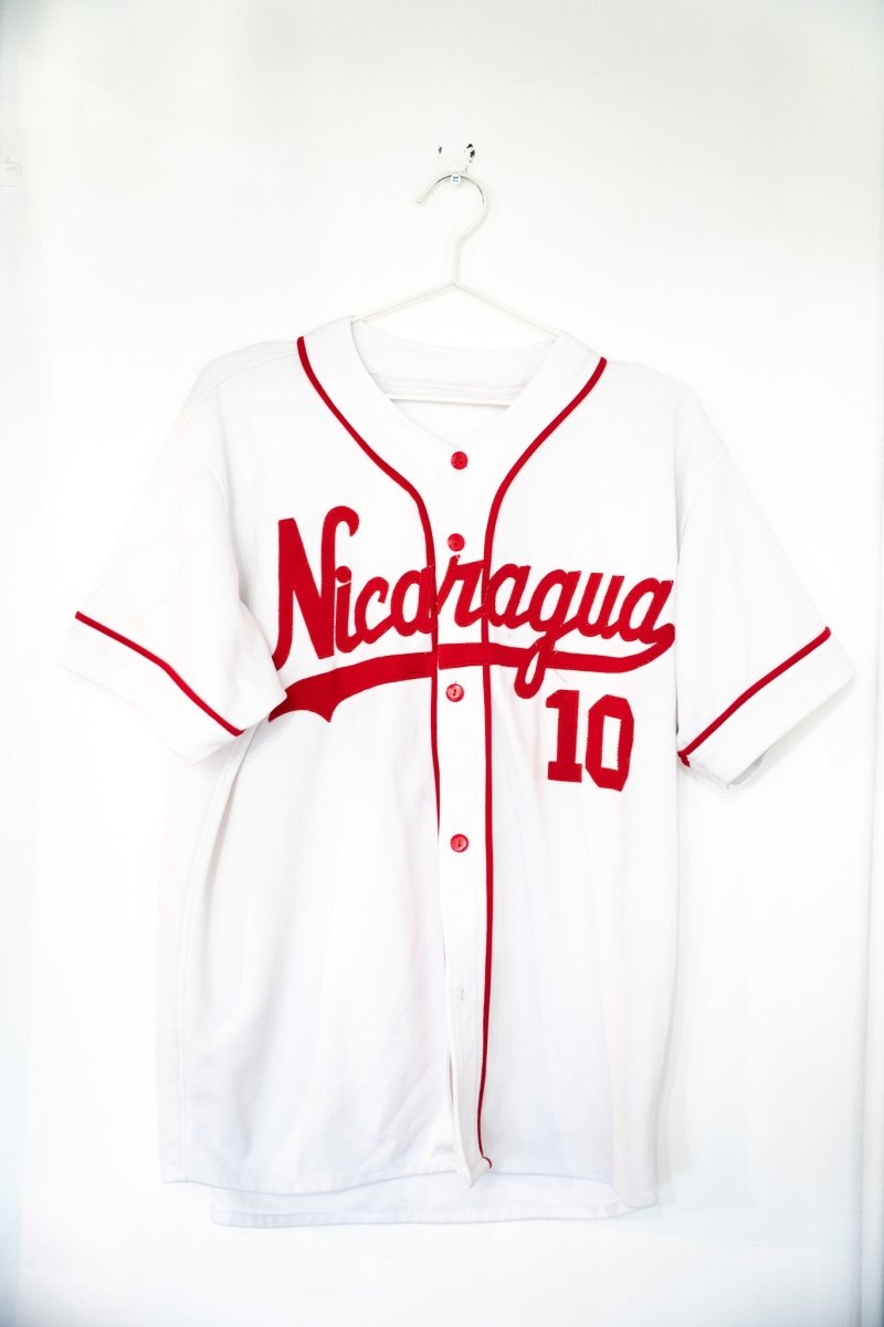 White vintage Nicaragua baseball jersey number 10 with red script Nicaragua lettering red piping and red buttons size Large