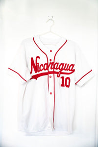 White vintage Nicaragua baseball jersey number 10 with red script Nicaragua lettering red piping and red buttons size Large
