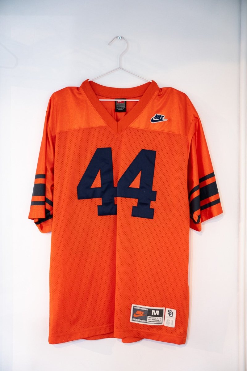 Orange vintage Nike Syracuse Ernie Davis 44 football jersey navy blue numbers striped sleeve cuffs mesh body Nike Swoosh SU patch size Medium