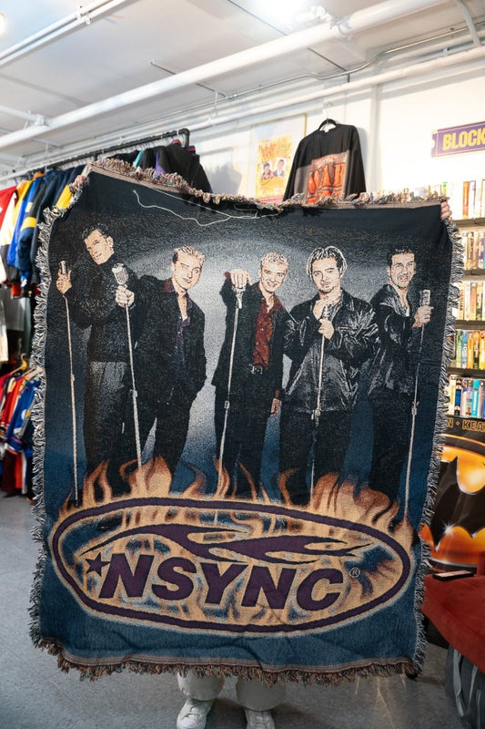 Vintage NSYNC woven tapestry blanket showing all five members in black suits with NSYNC star and flame logo at bottom