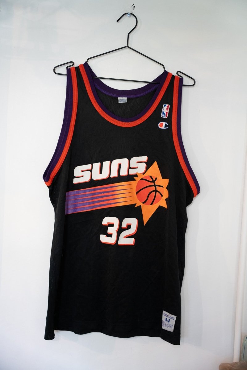 Vintage black Phoenix Suns Jason Kidd #32 Champion NBA jersey with orange and purple sunburst logo and striped trim