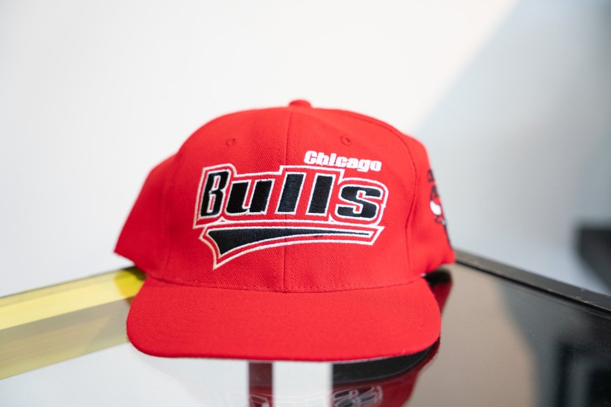 Red vintage Starter Chicago Bulls snapback hat with large black white embroidered Bulls script red underline swoosh bull logo side panel