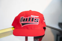 Red vintage Starter Chicago Bulls snapback hat with large black white embroidered Bulls script red underline swoosh bull logo side panel