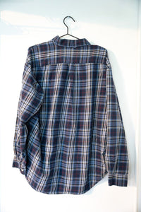 Tommy Hilfiger long sleeve flannel button-up shirt in red plaid with white collar, size XL, displayed on hanger
