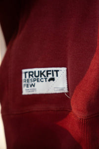 Trukfit oversized XXL sweater featuring dark fabric with embroidered logo on chest, displayed flat against neutral background