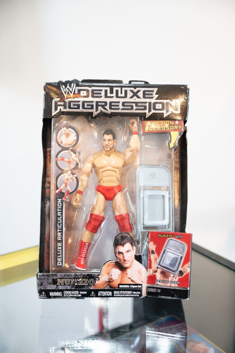 WWE Deluxe Aggression Nunzio action figure Series 16 original packaging red trunks boots denting chair accessory black gold card