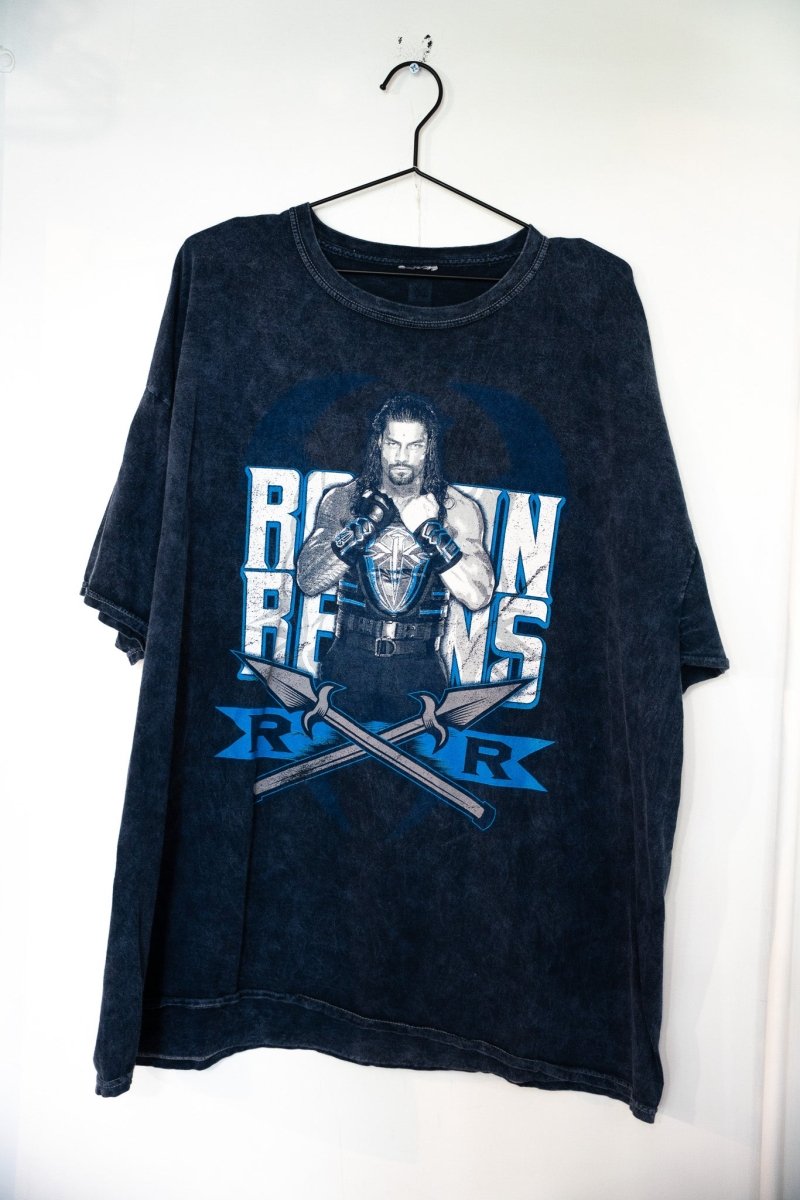 Acid wash dark navy WWE Roman Reigns t-shirt with Reigns in tactical vest blue silver ROMAN REIGNS lettering crossed spears RR logo size XL