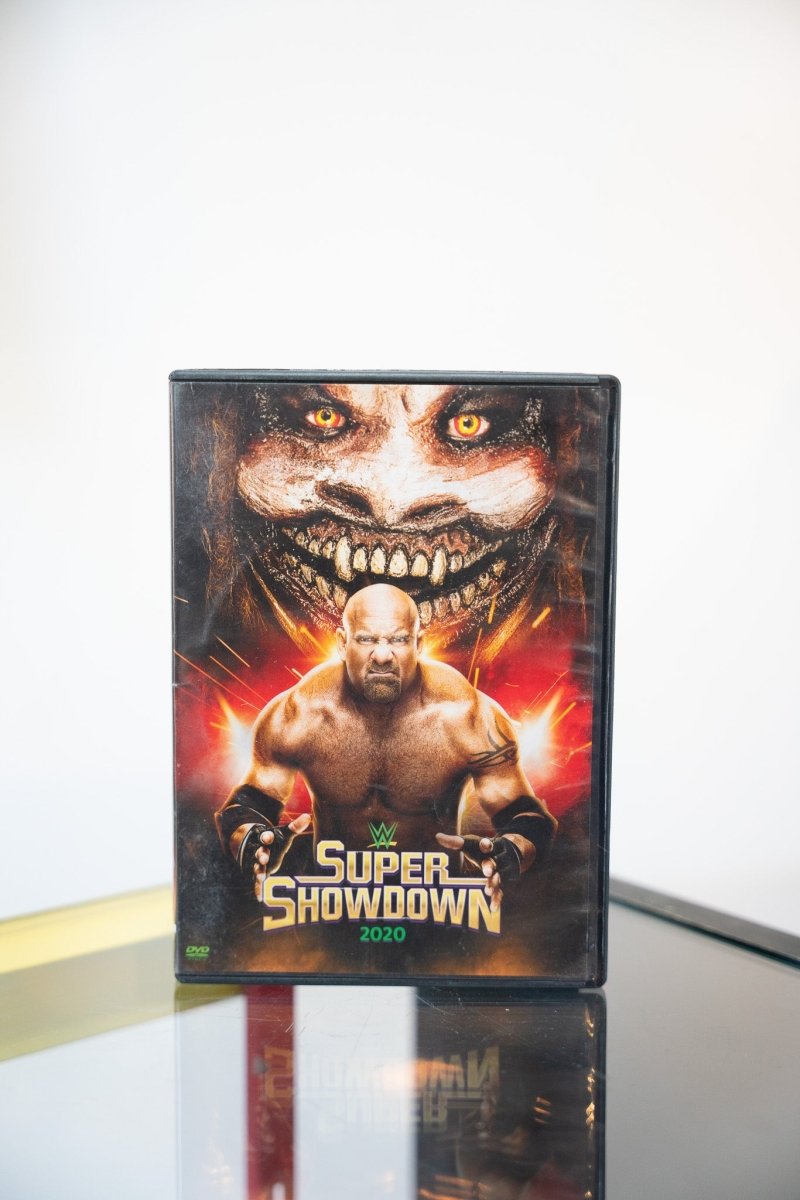 WWE Super ShowDown 2020 DVD dark cover The Fiend demonic face glowing eyes Goldberg flexing fire effects metallic green Super ShowDown text
