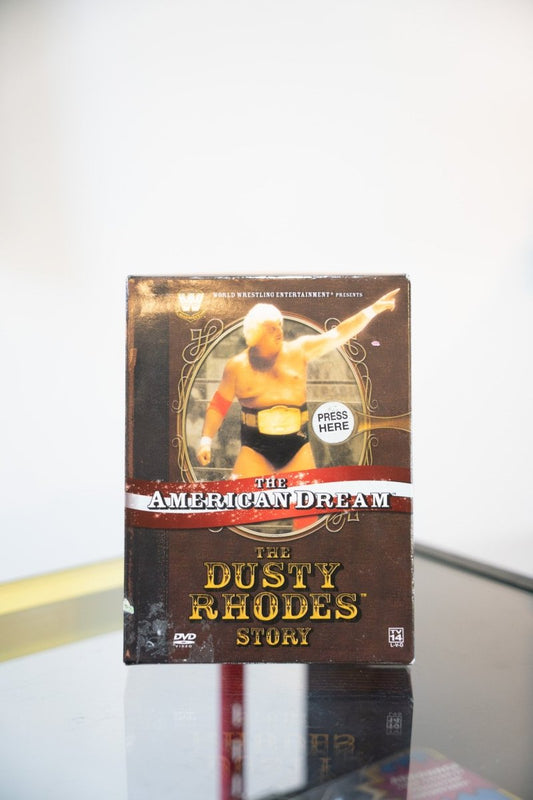 WWE The Dusty Rhodes Story The American Dream DVD book-style box gold ornate frame Dusty Rhodes posing Western-style gold text TV-14