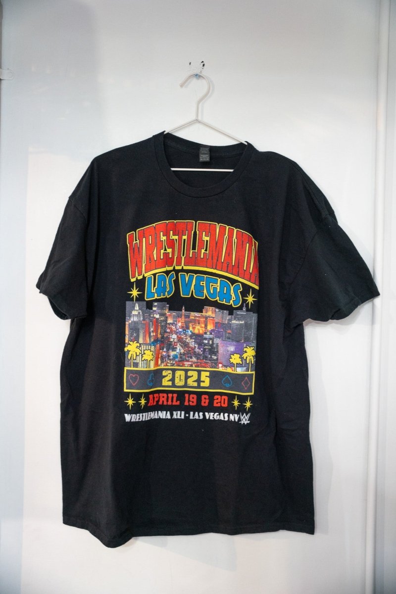 Black WWE WrestleMania 2025 Las Vegas t-shirt with red yellow WRESTLEMANIA lettering Vegas Strip skyline photo card suit symbols and April 19 20 dates size XXL