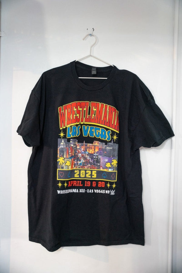 Black WWE WrestleMania 2025 Las Vegas t-shirt with red yellow WRESTLEMANIA lettering Vegas Strip skyline photo card suit symbols and April 19 20 dates size XXL