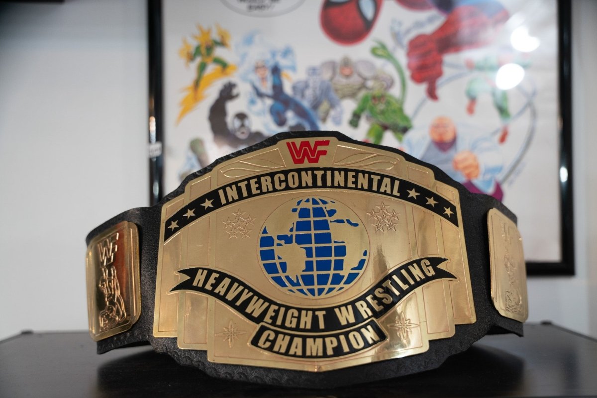 WWF Intercontinental Heavyweight Wrestling Champion replica belt with gold center plate featuring blue globe design and red WWF logo on black leather strap