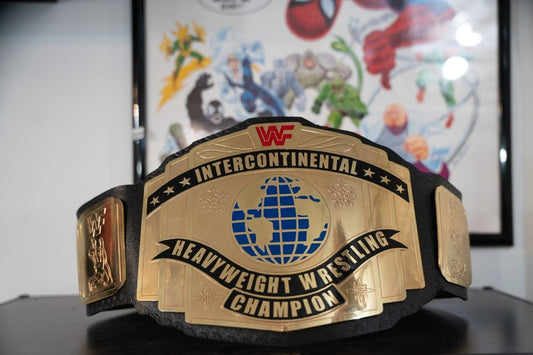 WWF Intercontinental Heavyweight Wrestling Champion replica belt with gold center plate featuring blue globe design and red WWF logo on black leather strap