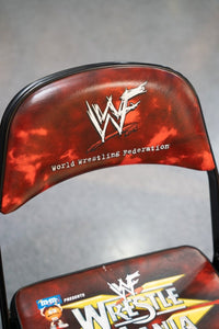 WWF WrestleMania 15 ringside chair with black metal frame and seat, circa 1999 wrestling event merchandise