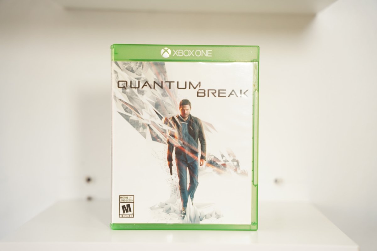 Xbox One Quantum Break case man dark jacket reality fracturing glass shards QUANTUM BREAK black text white background Mature