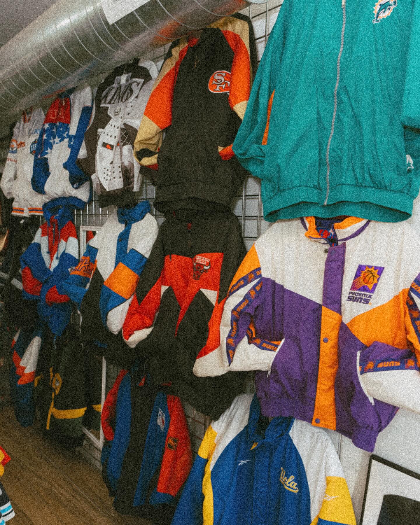Rack of 90s Starter jackets and tees on the shop floor